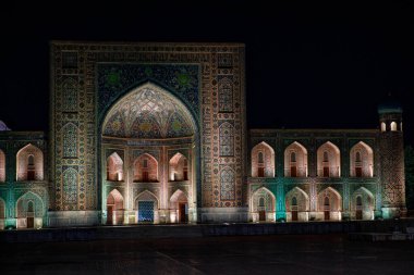 Semerkant, Özbekistan 'daki renkli Registan Meydanı. Gece Samarqand. Eski Arapça 'da Tanrı duvarlarda büyüktür..