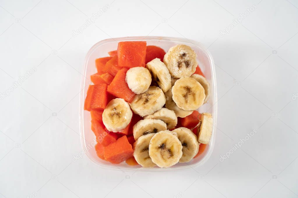 Fruits in a bowl on a white background.
