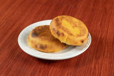 A fresh hot Arepa popular in Colombia and Venezuela made of two corn cakes that are fried until cheese between them melts, food clipart