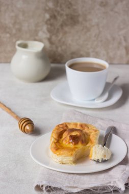 Beyaz tabakta bal süzme peynir güveç. Puding süzme peynir pişmiş.