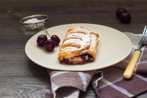 Lezzetli ev yapımı puf böreği doldurma kiraz ile pudra şekeri ile dekore edilmiştir. Bisküvi ile meyve doldurma 