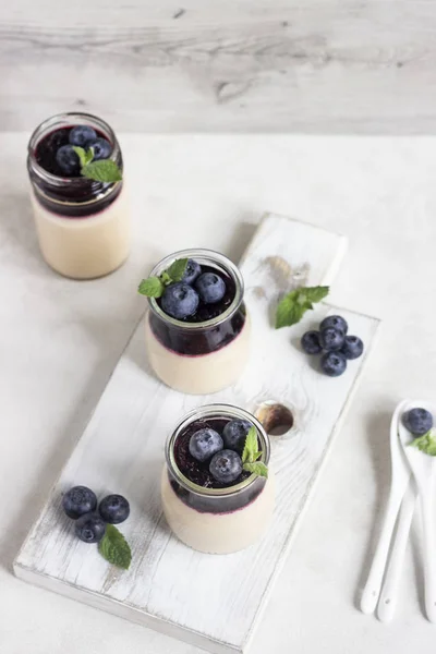 stock image Coffee panna cotta with berry coulis and fresh blueberries. Delicious Italian dessert panna cotta