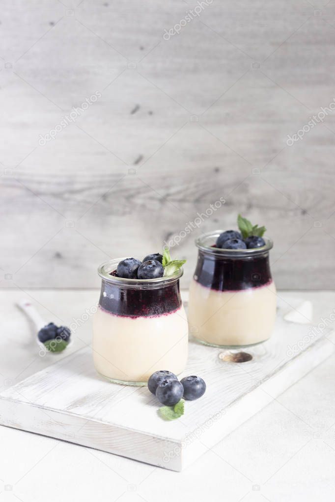 Coffee panna cotta with berry coulis and fresh blueberries. Delicious Italian dessert panna cotta