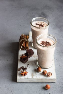 Gözlük gri beton zemin üzerine çikolata parçaları ile lezzetli çikolata meşrubatının (milkshake, kokteyl ya da iki yüzlü).