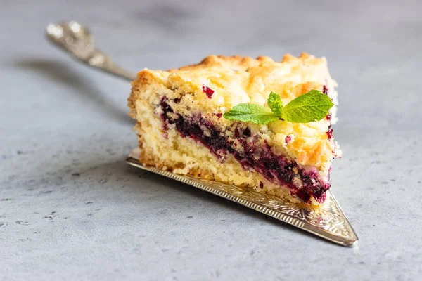 Closeup of piece of shortcrust fruit pie with fruit or jam  and crumble, selective focus.