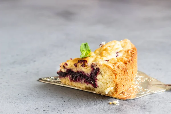 Closeup of piece of shortcrust fruit pie with fruit or jam  and crumble, selective focus.