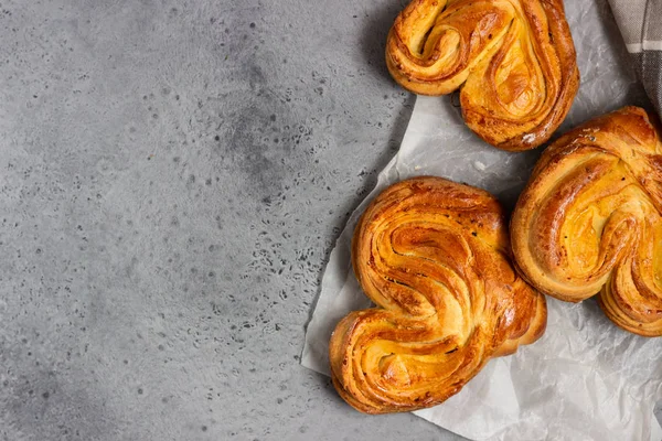 Yeast sweet buns with sugar in the shape of a heart. Traditional russian sweet buns.