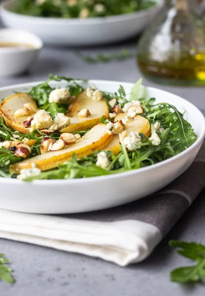 Arugula, gorgonzola cheese, caramelized pear and nut salad. Healthy food. Light breakfast, lunch or dinner.
