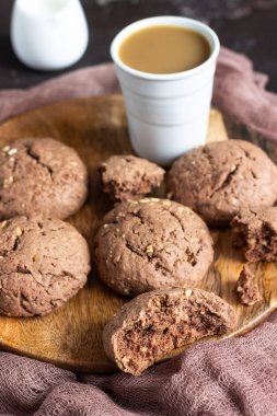 Delicious chocolate cookies with nuts on dark old concrete table. Copy space.