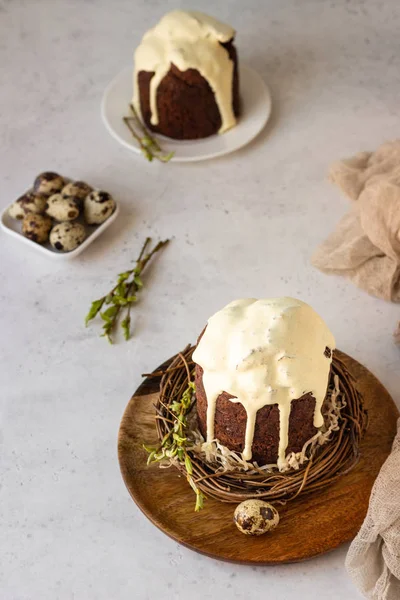 Traditional Orthodox Easter sweet bread or cake with chocolate. Chocolate Kulich  decorated with orange glaze.