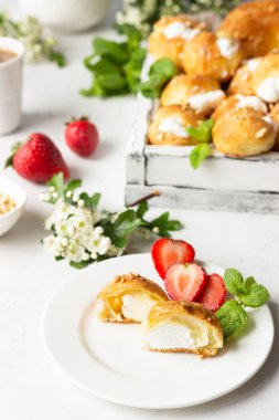 Profiteroles (choux la crme) - Fransız choux pasta topları taze çilek, nane ve kahve fincan ile süzme peynir ve krema ile dolu.