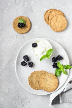 Gri bir tabak tabaktabak tabaktabak tabaktabak tabaktabak tabaktabak tabaktabak tabaktabak tabaktabak tabaktabak tabaktabaktabak tabaktabakisi ile ince gevrek kepekli kraker, böğürtlen ve nane. 