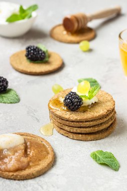 Krem peynir, böğürtlen, üzüm, nane ve bal ile ince gevrek kepekli kraker. 