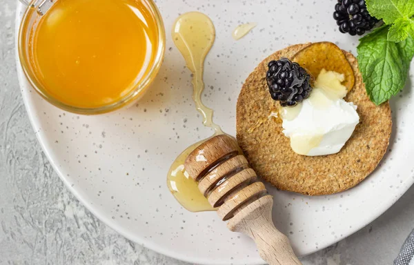 Krem peynir, böğürtlen, üzüm, nane ve bal ile ince gevrek kepekli kraker. 