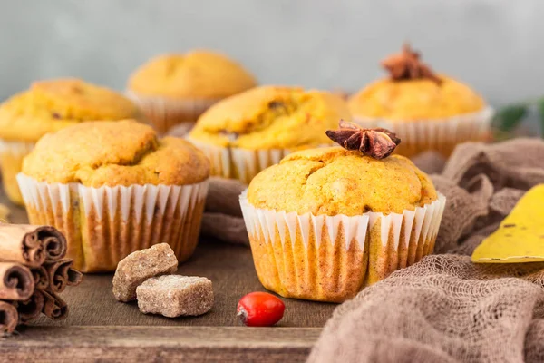 Sweet pumpkin or carrot muffins with fall spices. Autumn dessert. Healthy baking concept. Copy space.