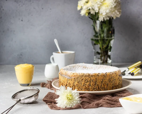 Poppy seed cake with powdered sugar and custard with a cup of coffee. Traditional Polish poppy seed cake  Makovnik. Delicious breakfast or dessert.