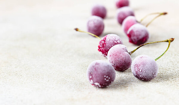 Frozen sweet black cherries covered with hoarfrost. Summer food. Useful, proper nutrition.