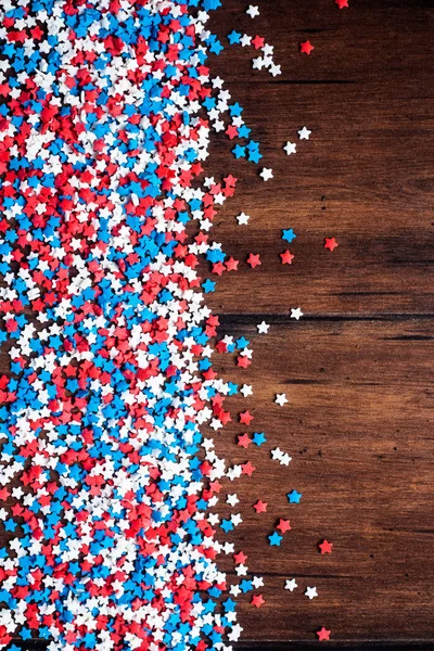 American Independence day background with blue, white and red mixed stars. Celebration of American independence day, the 4th of July (the Fourth of July). Holiday concept. Top view. With copy space.