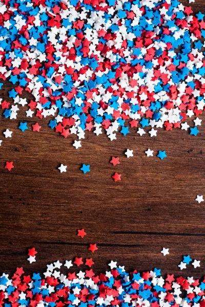 American Independence day background with blue, white and red mixed stars. Celebration of American independence day, the 4th of July (the Fourth of July). Holiday concept. Top view. With copy space.