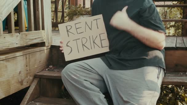 Man Holding Rent Strike Sign — Stock Video