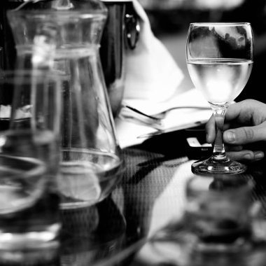 bir kadeh beyaz şarap tutan el