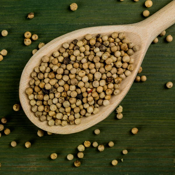 Wooden Spoon Full of White Pepper Corns