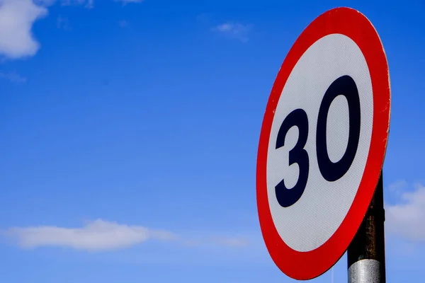 Road Traffic 30mph Speed Limit Sign, Against A blue Summer Sky — Stock Image Road Traffic 30Mph Speed Limit Sign Blue Summer Sky Stock Image