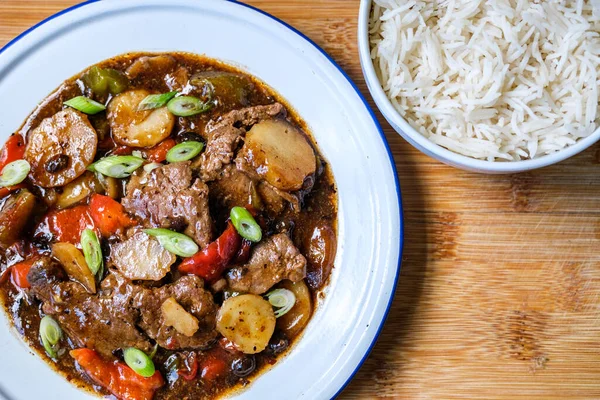 Londra İngiltere, 11 Eylül 2025, Klasik Çin usulü biftek ve haşlanmış beyaz pirinçli siyah fasulye menüsü.