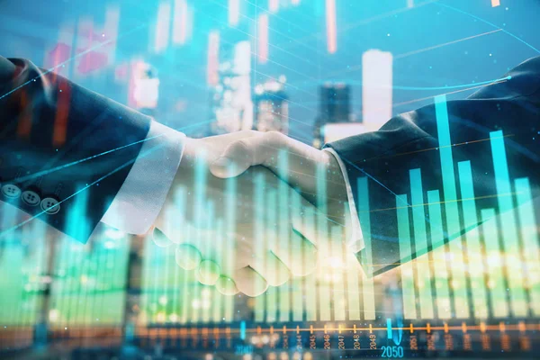 Double exposure of financial chart on cityscape background with two businessmen handshake. Concept of financial analysis and investment opportunities