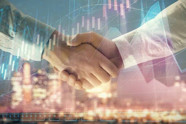 stock image Double exposure of financial chart on cityscape background with two businessmen handshake. Concept of financial analysis and investment opportunities