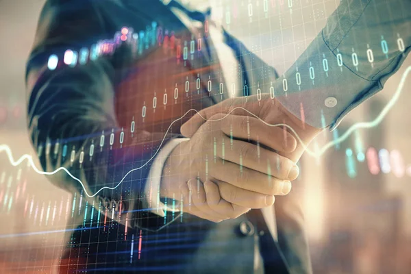 Double exposure of financial graph on cityscape background with two businessman handshake. Concept of stock market deal