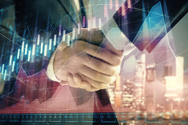 Double exposure of financial chart on cityscape background with two businessmen handshake. Concept of financial analysis and investment opportunities