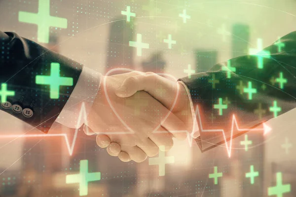 Double exposure of heart drawing on city view background with handshake. Concept of medical education — Stock Photo, Image