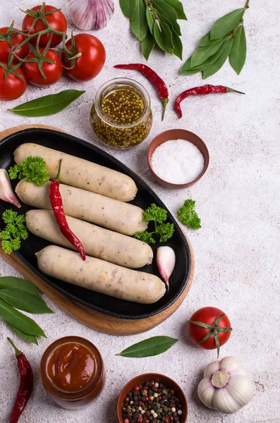 Raw white sausages with cheese and spices. Selective focus.