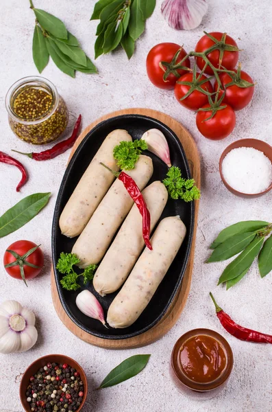 Raw white sausages with cheese and spices. Selective focus.