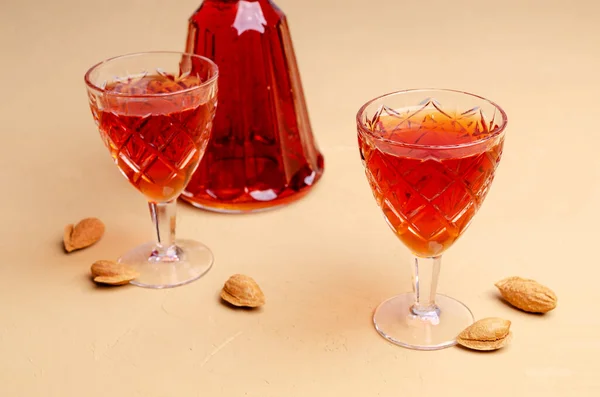 Traditional brown almond liquid in a glass on a stone background. Selective focus.