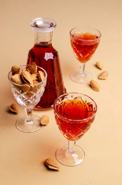 Traditional brown almond liquid in a glass on a stone background. Selective focus.