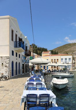 Kastellorizo, Yunanistan-Ağustos 10:Restaurant masa ve sandalyeler denizin kenarında. Ağustos 10,2018 Kastellorizo, Yunanistan.