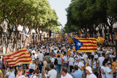 People wave 'Esteladas' (pro-independence Catalan flags) as they gather during a pro-independence demonstration, on September 11, 2017 in Barcelona during the National Day of Catalonia, the 'Diada'. clipart