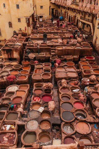 View inside of old medina in Fes, a traditional and old tannery with workers working making methods of leather in the city Fes, Morocco, in april of 2019.