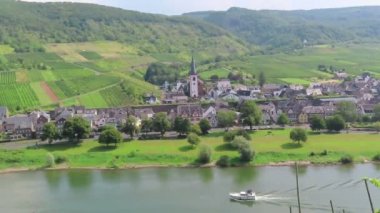 Bruttig-Fankel, Rheinland-Pfalz / Almanya 26 Ağustos 2019: Moselle Nehri'ndeki Bruttig-Fankel şehir manzarası. Motorlu tekne geçiyor. Bağ manzarası.