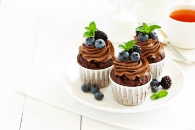 Çikolatalı kekler, çikolata kremalı ve taze dutlu..