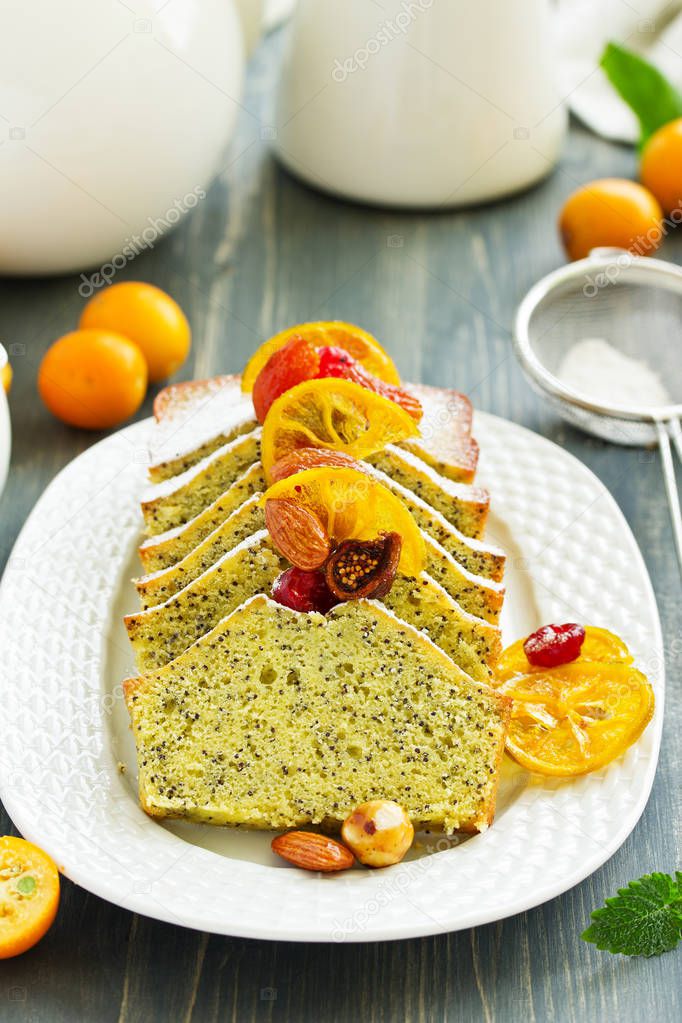 lemon cake with poppy seeds and candied fruits.