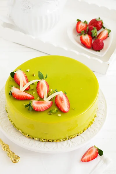 Delicious strawberry-pistachio mousse cake with a smooth glaze.