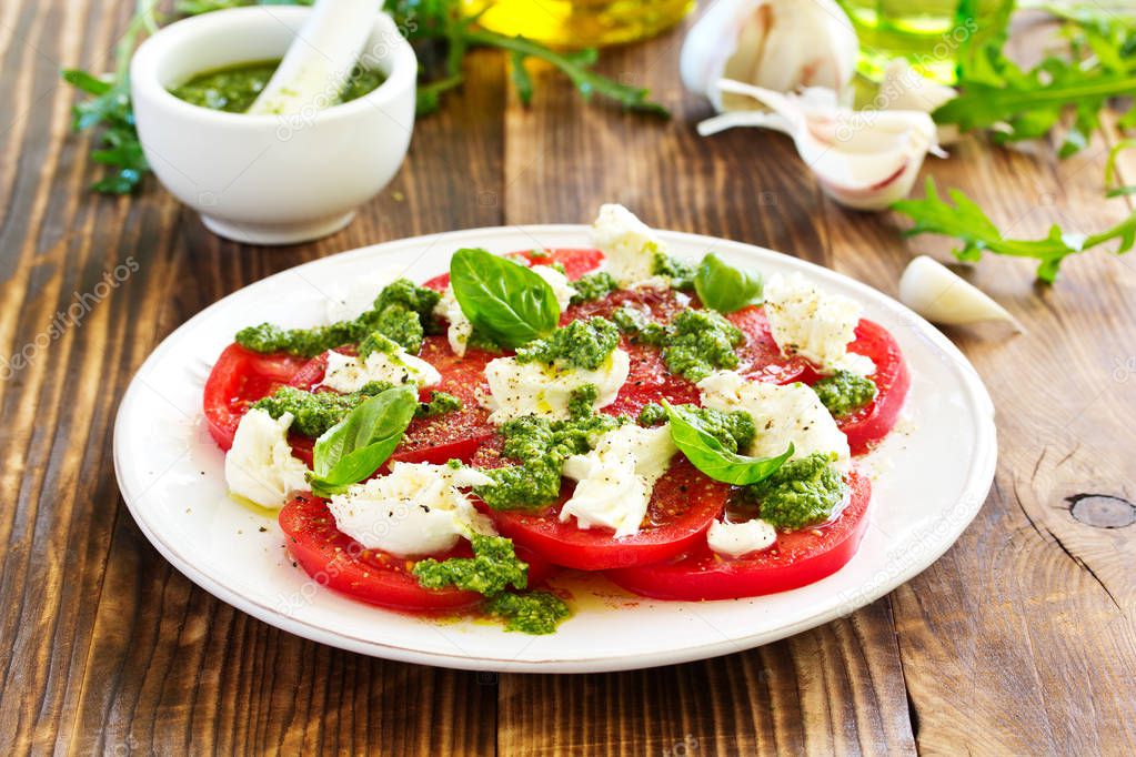 Delicious salad of tomato, mozzarella and pesto.