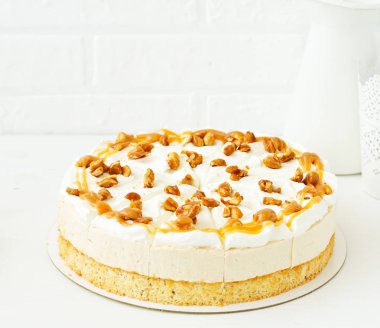 A wonderful caramel cheesecake with homemade caramel, nuts and chocolate. clipart