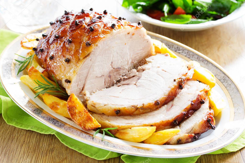 Roast pork with orange glaze, decorated with cloves.