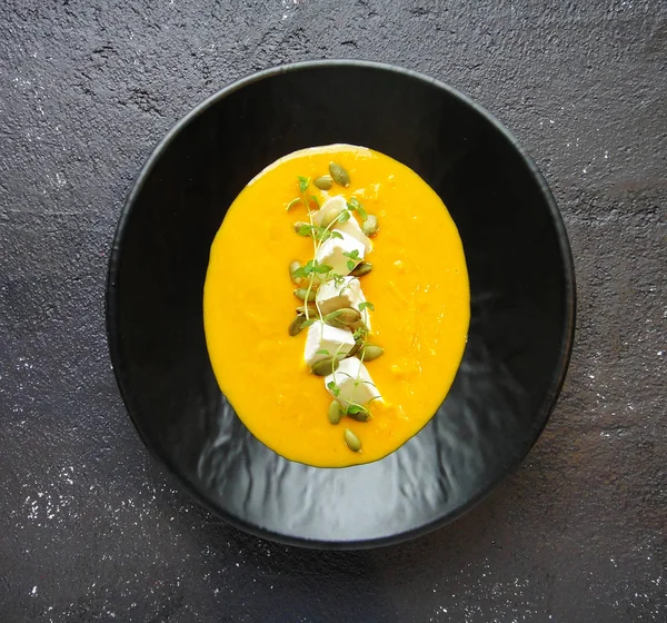 Pumpkin soup with seeds and cheese