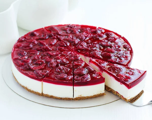 Cold cheesecake with cherry jelly.