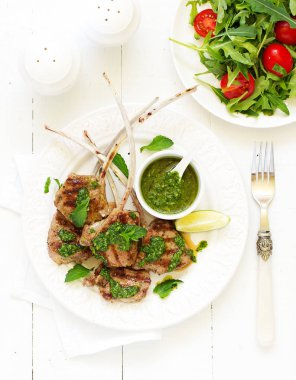 Kuzu pirzolası nane-sarımsak sosu ve kuskus ile kemik üzerinde.